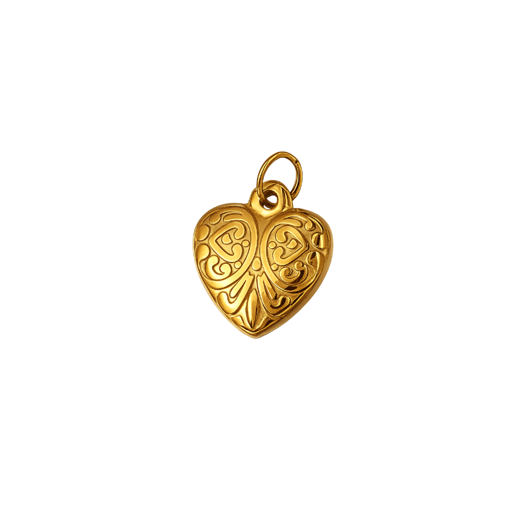 A gold heart-shaped pendant with intricate engraved scrollwork and a small top loop, shown on a plain white background.