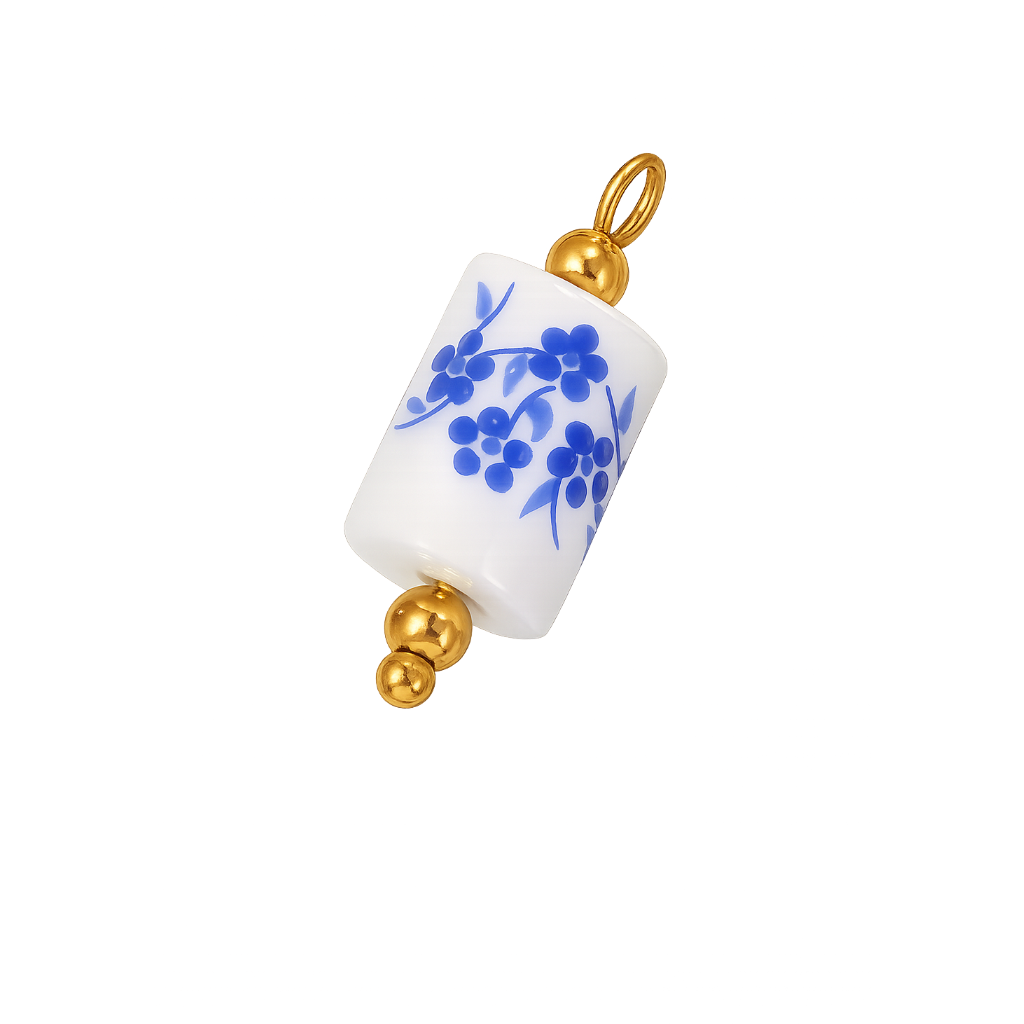 A white cylindrical pendant charm with a blue floral pattern and gold-tone metal accents, shown on a plain white background.