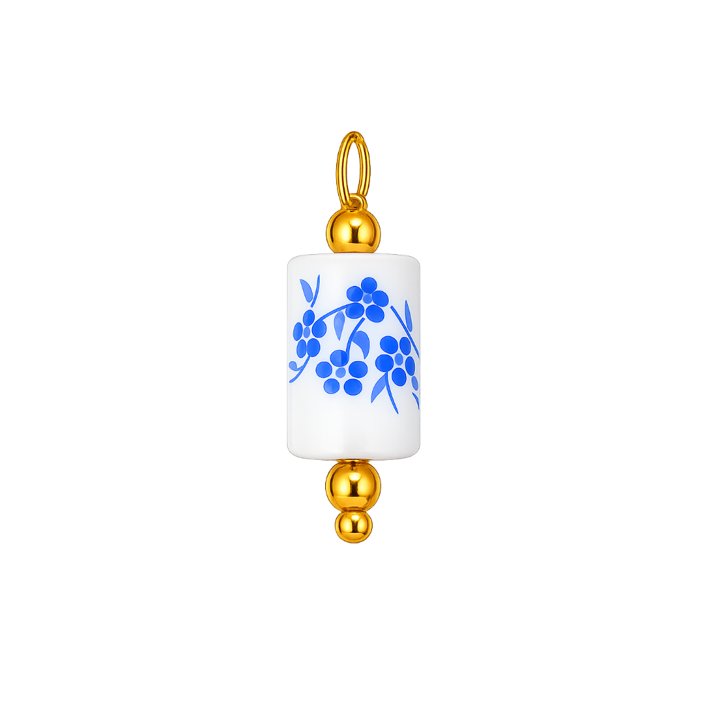A cylindrical white ceramic pendant charm with a blue floral pattern, finished with polished gold-tone metal caps and a hanging loop at the top, shown on a plain white background.