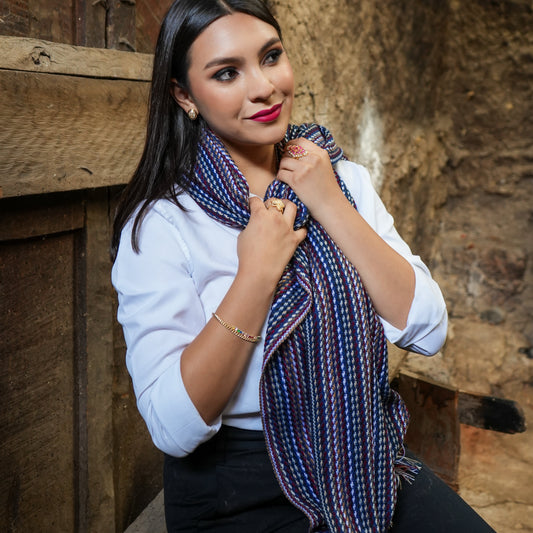 Navy and burgundy striped Ecuadorian scarf worn at the neck with a white blouse, Alennya.